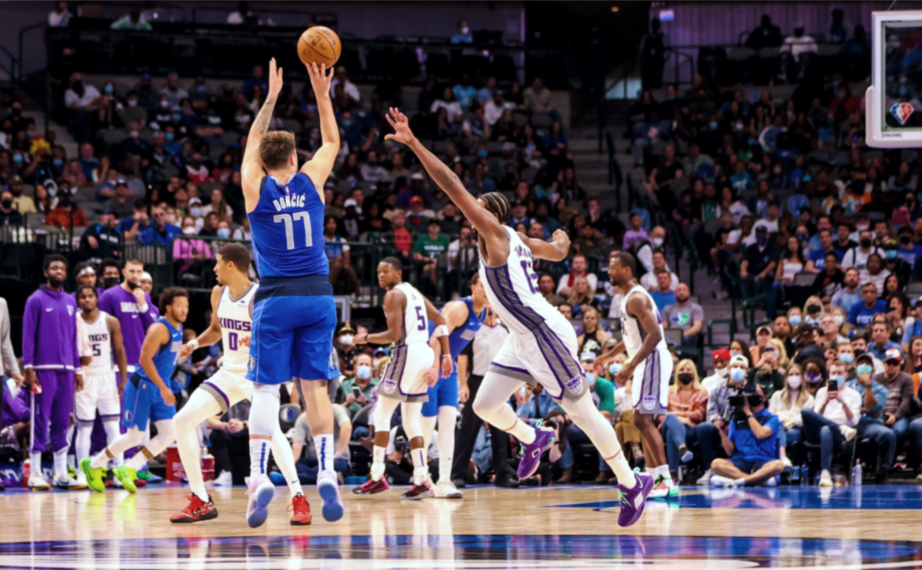 Luka Dončić shooting a three-pointer during a game