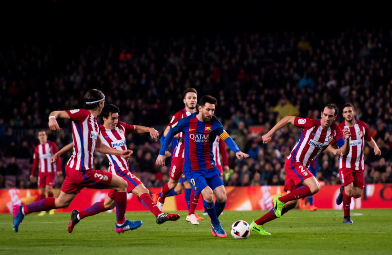 Lionel Messi dribbling past defenders during a match