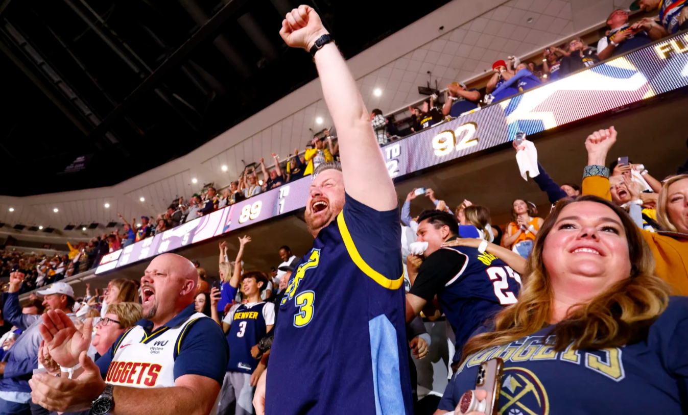 Enthusiastic basketball fans cheering during a major NBA match